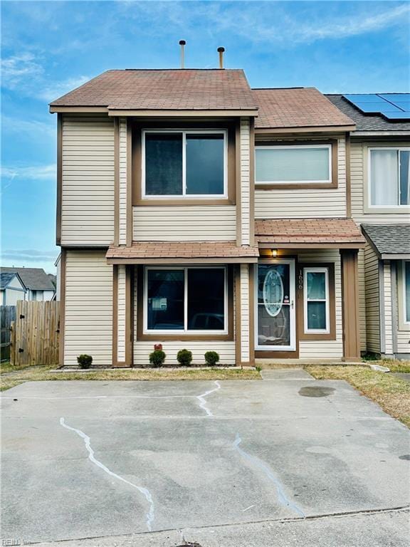 townhome / multi-family property with fence and roof mounted solar panels