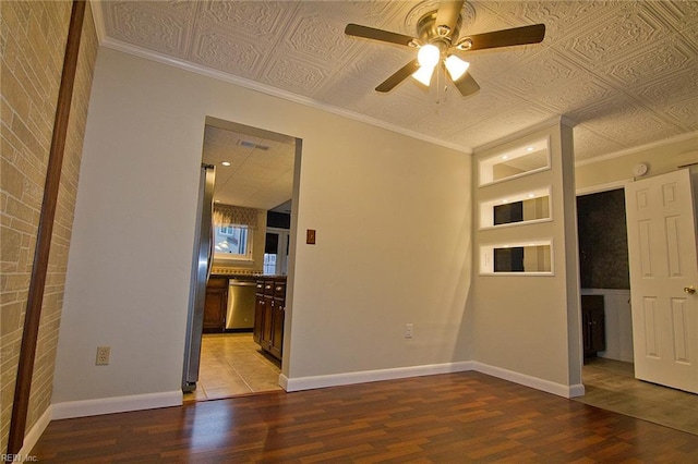 unfurnished room featuring wood finished floors, an ornate ceiling, and baseboards