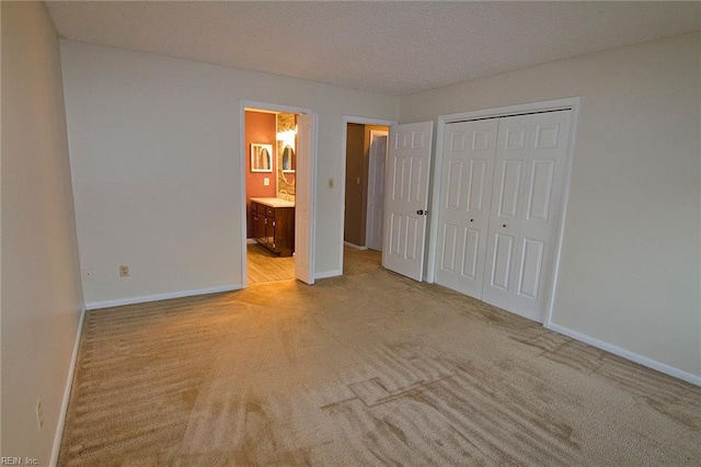 unfurnished bedroom with a closet, carpet flooring, and baseboards