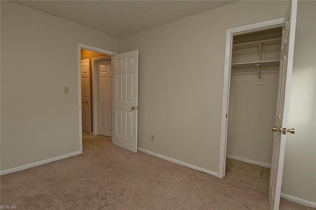 unfurnished bedroom with carpet floors, a closet, and baseboards