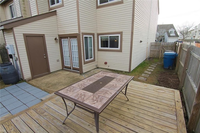 wooden deck with a fenced backyard