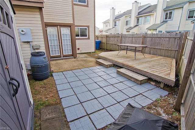 view of patio with a residential view, a fenced backyard, and a wooden deck