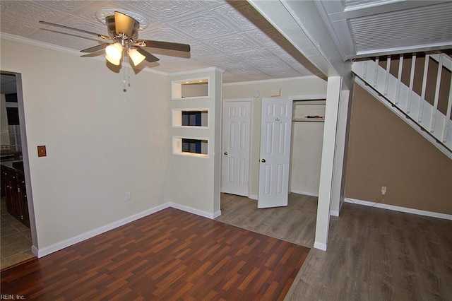 unfurnished bedroom featuring ornamental molding, wood finished floors, an ornate ceiling, and baseboards