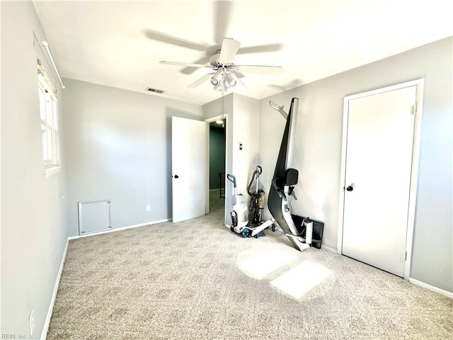 exercise area with visible vents, carpet, a ceiling fan, and baseboards