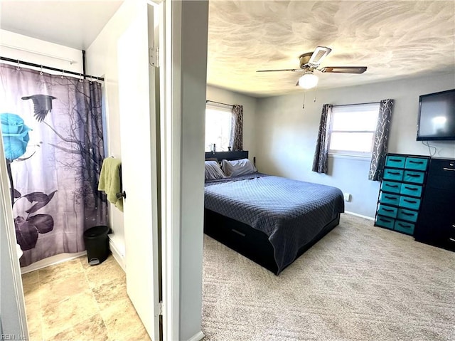 bedroom featuring multiple windows, a ceiling fan, and carpet flooring