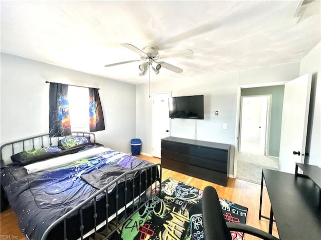 bedroom featuring a ceiling fan and wood finished floors