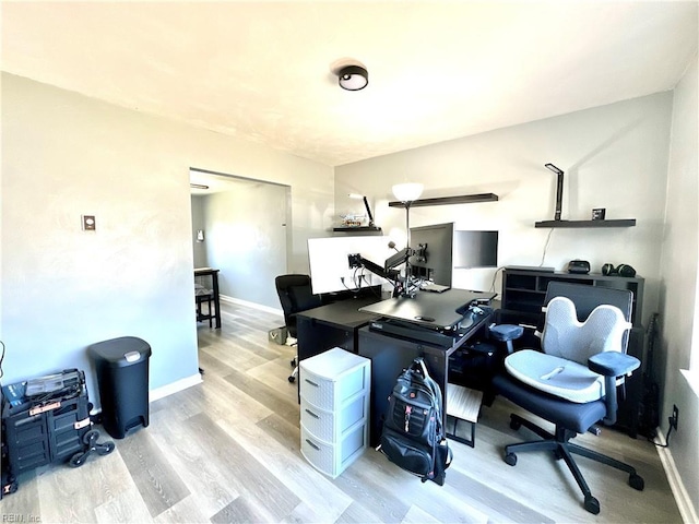 office area with baseboards and wood finished floors