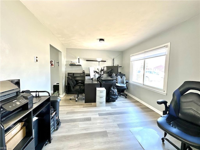 office area with baseboards and light wood-style floors