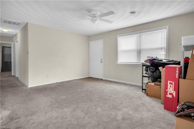 interior space with baseboards, carpet, visible vents, and a ceiling fan