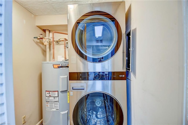 interior space with water heater, laundry area, and stacked washer / drying machine