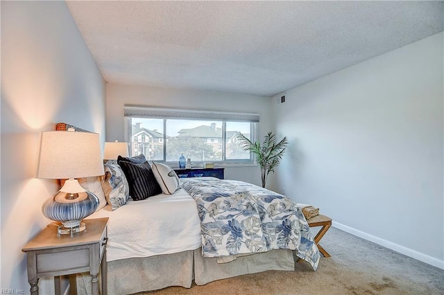 carpeted bedroom featuring visible vents, a textured ceiling, and baseboards