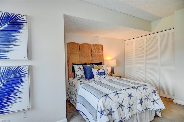 carpeted bedroom with a closet and a textured ceiling