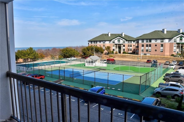 view of tennis court with fence