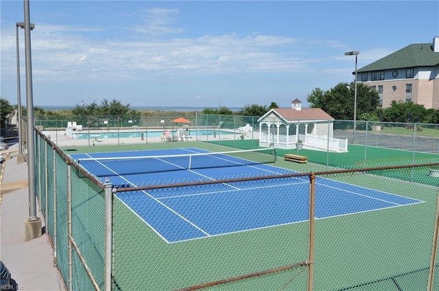 view of sport court featuring fence