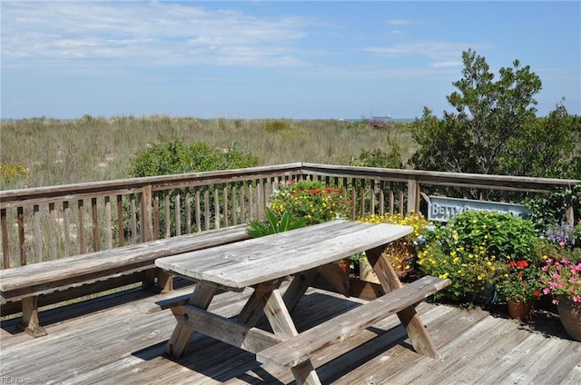 wooden terrace with outdoor dining space