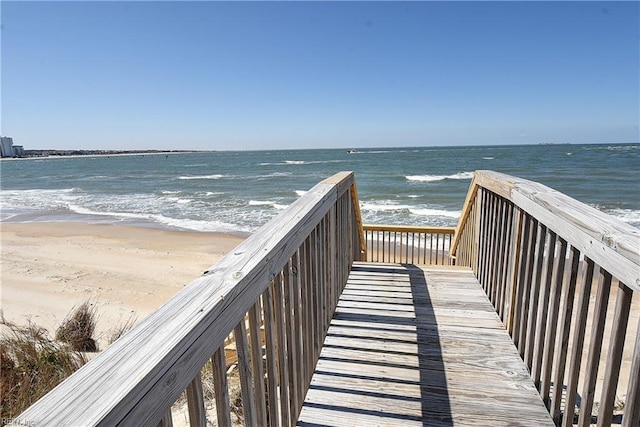 view of home's community featuring a water view and a beach view