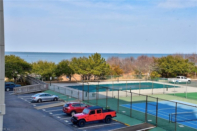 exterior space featuring a water view and fence