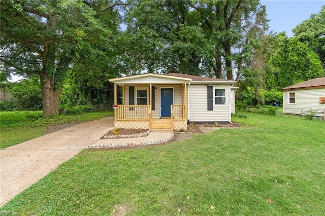 bungalow-style home with a front lawn and a porch