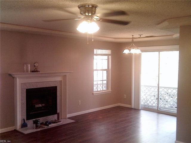 unfurnished living room featuring a textured ceiling, ceiling fan with notable chandelier, a high end fireplace, baseboards, and dark wood-style floors