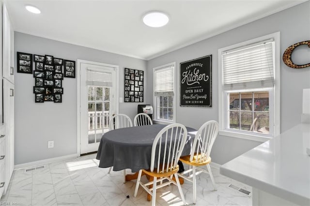 dining area with crown molding, marble finish floor, visible vents, and baseboards