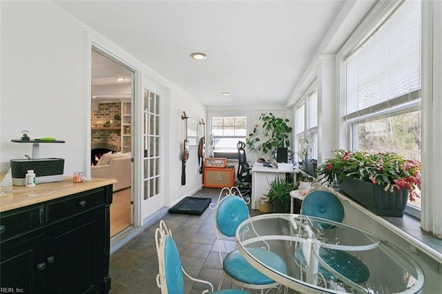 sunroom / solarium with a fireplace