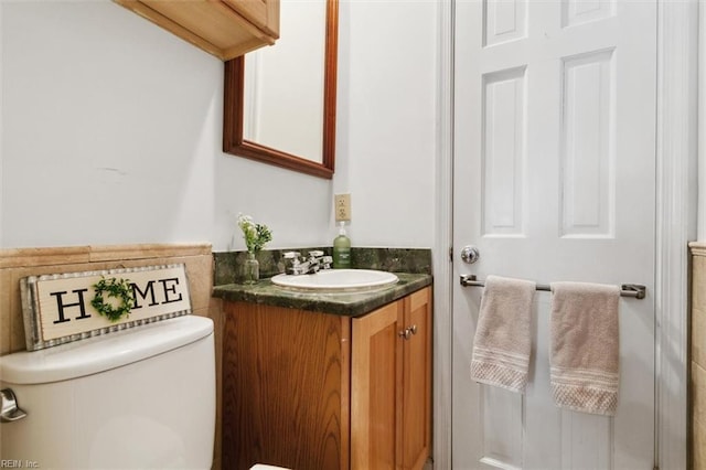 bathroom featuring vanity and toilet