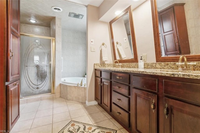 full bathroom with tile patterned flooring, visible vents, a sink, and a bath