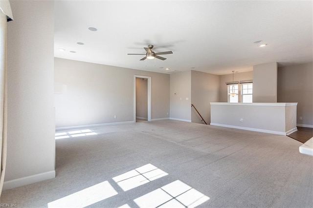 unfurnished room featuring ceiling fan, carpet floors, and baseboards