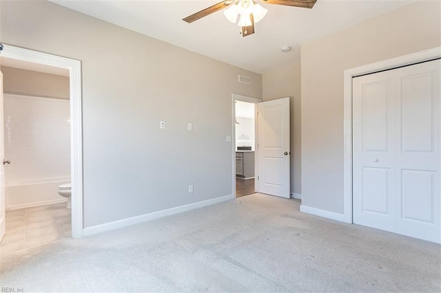 unfurnished bedroom featuring a closet, light carpet, visible vents, and baseboards