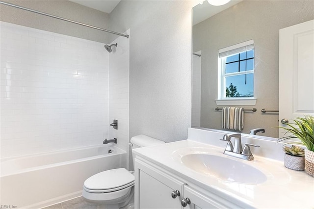 bathroom featuring toilet, shower / bath combination, a textured wall, and vanity