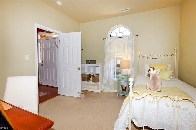 carpeted bedroom featuring visible vents