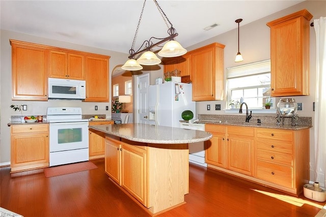 kitchen featuring white appliances, visible vents, dark wood finished floors, and light stone countertops