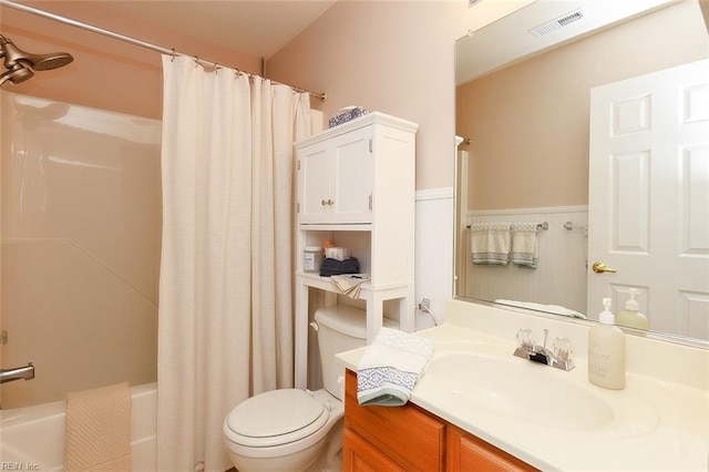 full bathroom featuring visible vents, vanity, toilet, and shower / bath combo with shower curtain