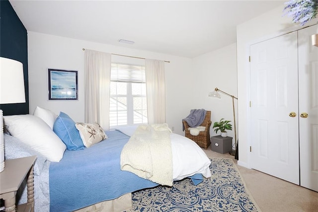 bedroom with visible vents and light colored carpet