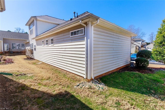 view of side of home featuring a lawn