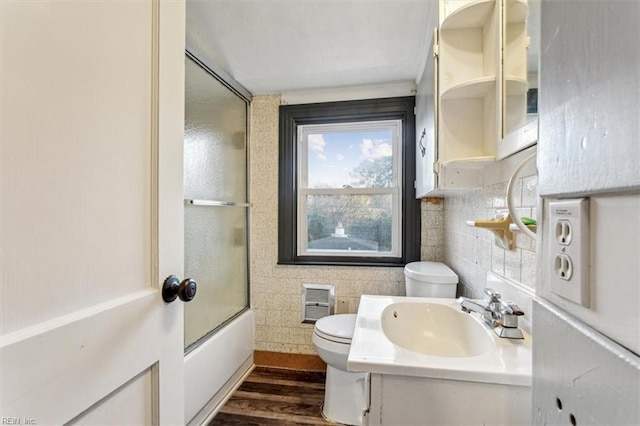 full bathroom with visible vents, toilet, enclosed tub / shower combo, wood finished floors, and vanity