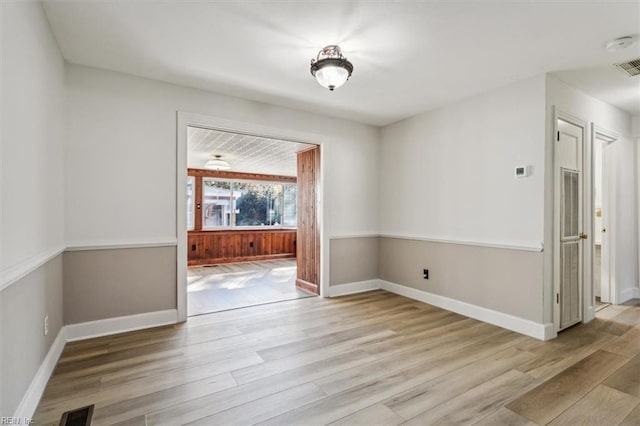 unfurnished dining area featuring wood finished floors, visible vents, and baseboards