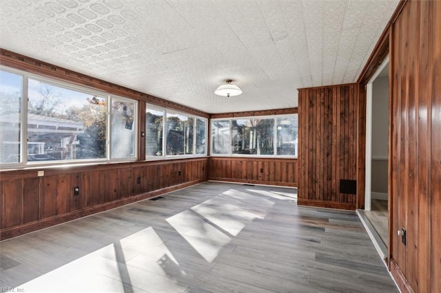 unfurnished sunroom featuring an ornate ceiling