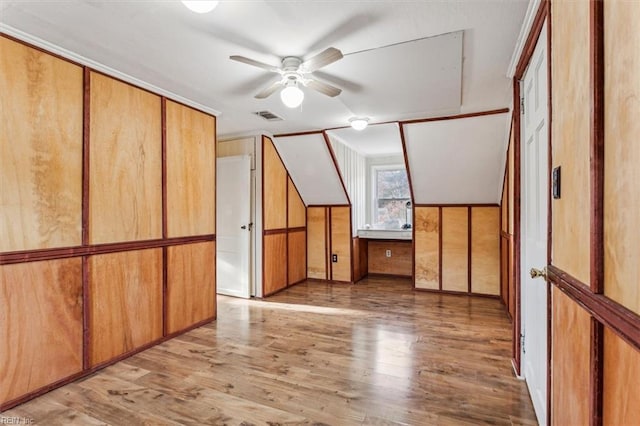 additional living space featuring wood finished floors, visible vents, and a ceiling fan