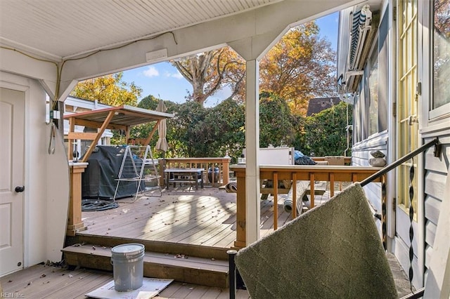 wooden deck featuring a grill