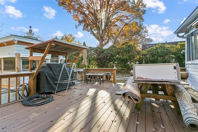 wooden terrace with a grill