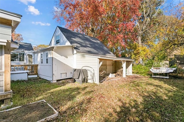 back of house with a lawn