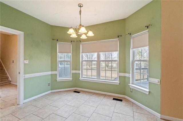 unfurnished dining area featuring baseboards, visible vents, tile patterned flooring, stairs, and a chandelier