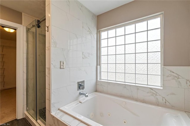 full bathroom with a shower stall and a whirlpool tub