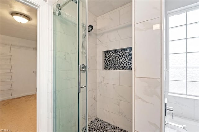 full bath with a shower stall and a spacious closet