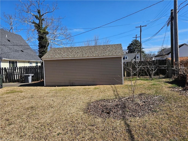 exterior space featuring an outbuilding, fence, and a storage unit