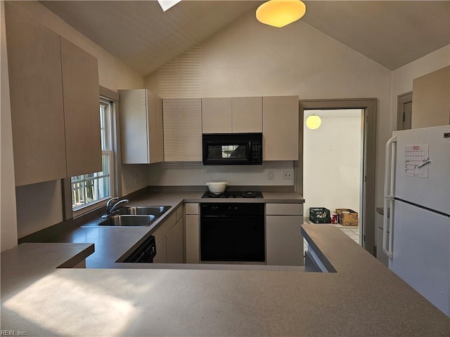 kitchen with black appliances, vaulted ceiling, and a sink