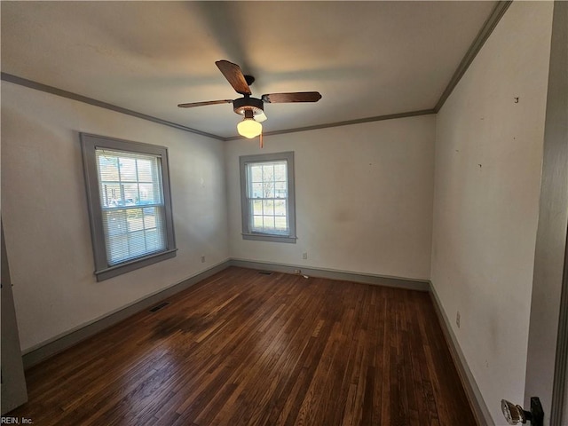 unfurnished room featuring visible vents, ornamental molding, wood-type flooring, and baseboards