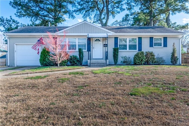 ranch-style house with an attached garage, driveway, a front lawn, and brick siding