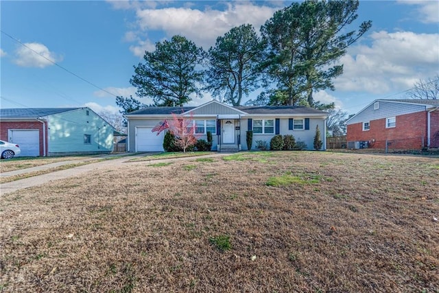 ranch-style house featuring a garage, a front yard, driveway, and fence